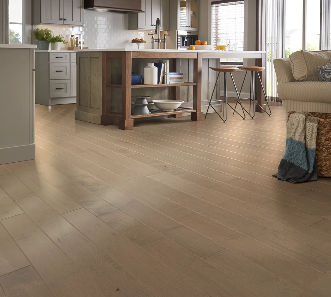 Wide plank hardwood in an open concept kitchen and living room space | Sterling Carpet & Flooring